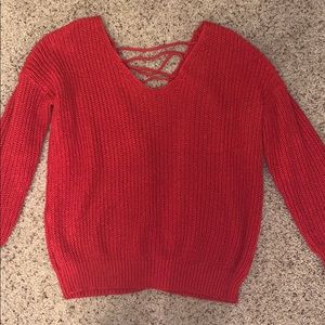 Red knit v-neck sweater with lace up back